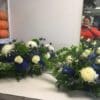 A couple of flower arrangements on top of a table.