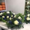 A table with three different flower arrangements on it.