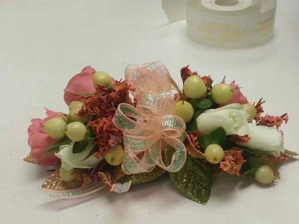 A bouquet of flowers with leaves and ribbons.