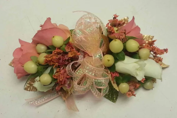 A bouquet of flowers with grapes and leaves.