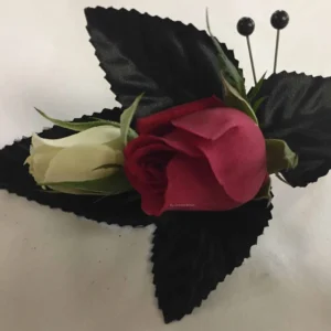 A red rose and white flower with black leaves.