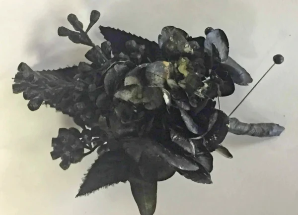 A black flower is sitting on top of the table.