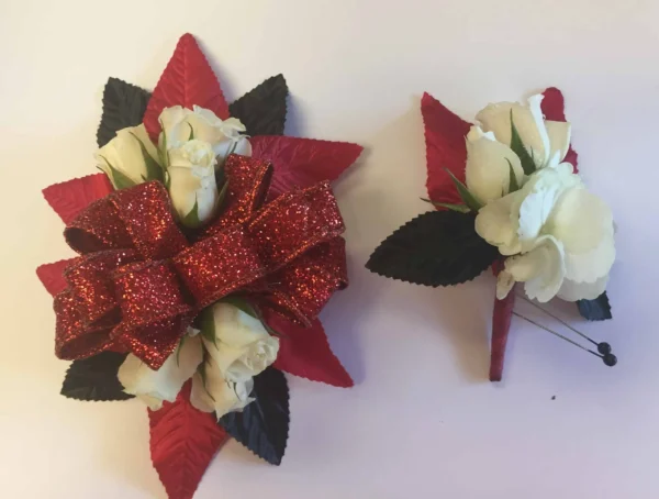 A red bow and white flowers are on the table.