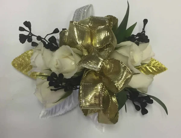 A gold bow with white flowers and black leaves.