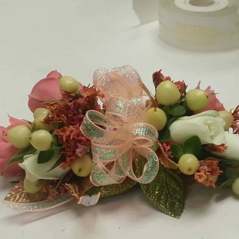 A bouquet of flowers with leaves and ribbons.