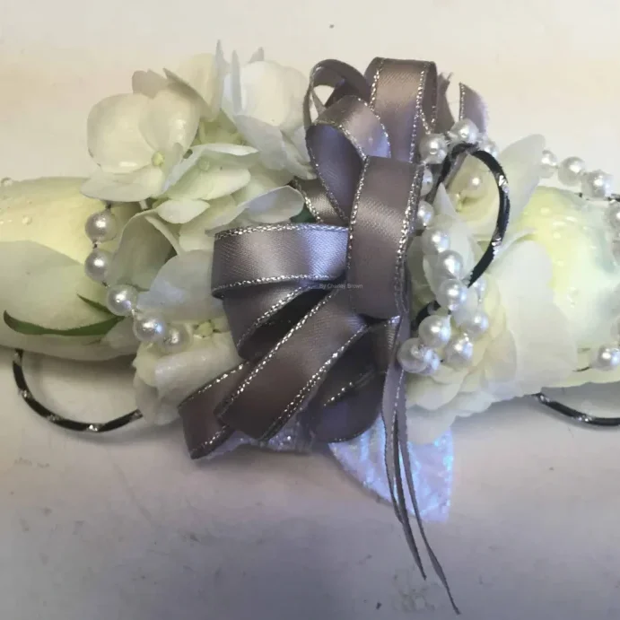 A close up of a flower arrangement with pearls