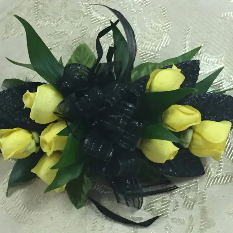 A bouquet of yellow roses with black ribbon.