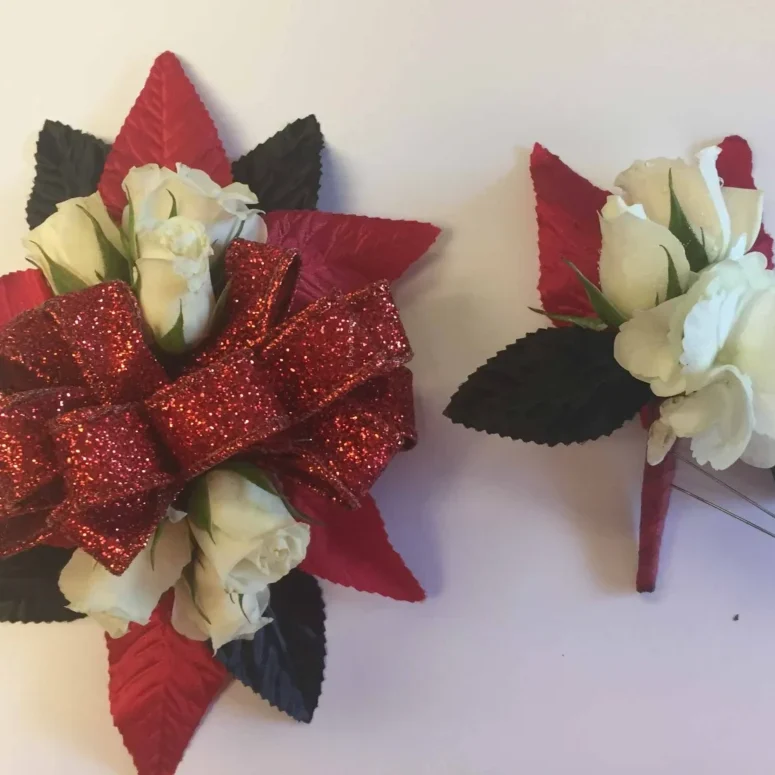 A red bow and white flowers are on the table.