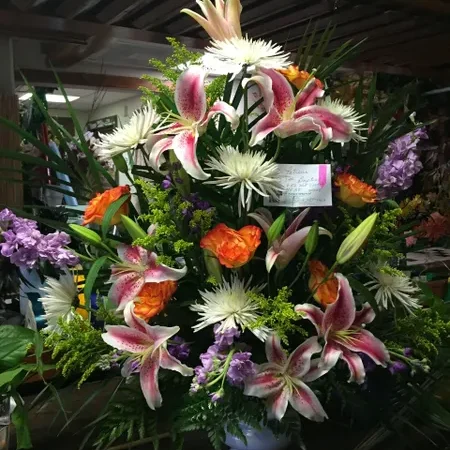 A bouquet of flowers in a vase on display.