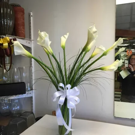 A vase with flowers on top of the table.