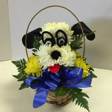 A dog basket with flowers and blue ribbon.