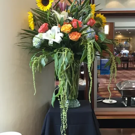 A large vase of flowers on top of a table.