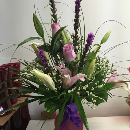 A bouquet of flowers in a vase on the table.
