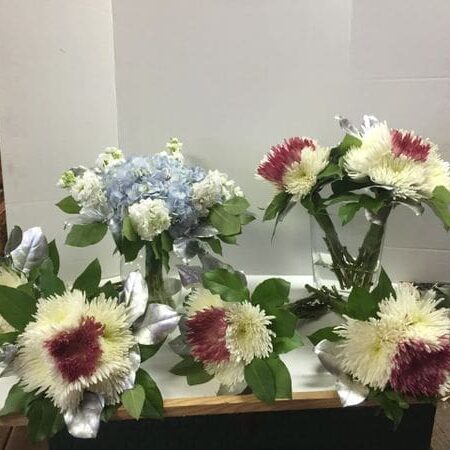 A table with several different flowers on it.
