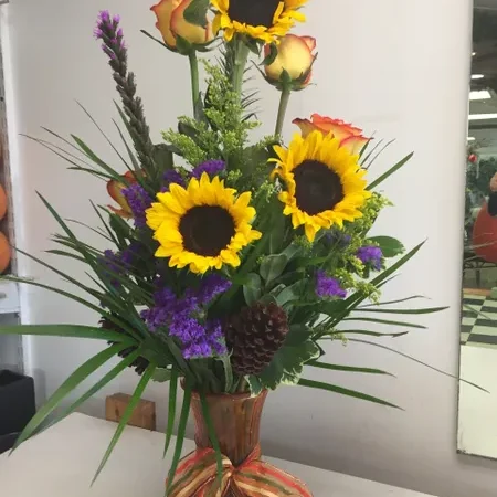 A vase filled with flowers on top of a table.